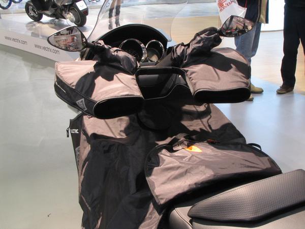 Gloves to drive motorcycle in winter
On Vectrix on the booth had been special equipped for driving in winter. Gloves are mounted on the grips, the driver puts his hands into the gloves to drive.